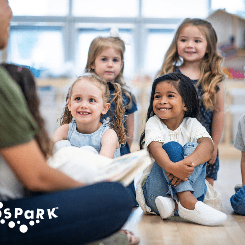 Children and parents engaging in activities at KidSpark, demonstrating community support and resources for working parents